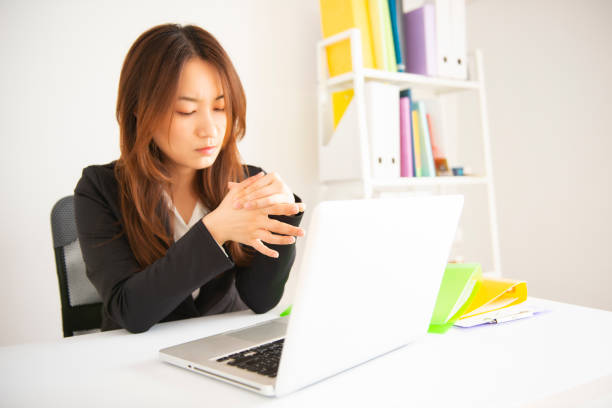 istock businesswoman holding her wrist pain from using computer 1071252820
