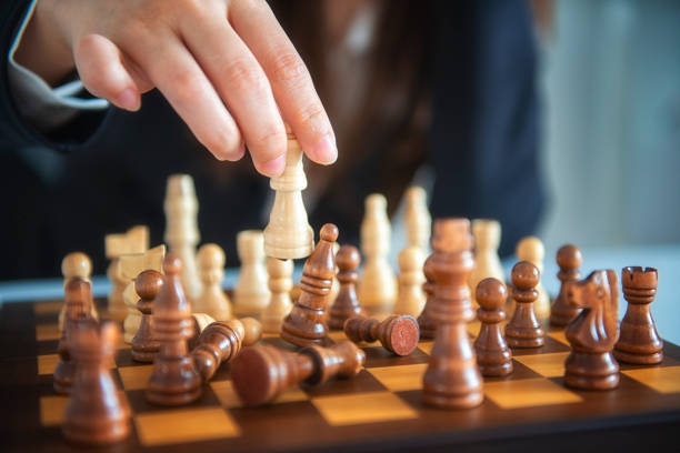 istock Businessman moving chess figure with team behind - strategy or leadership concept 1071252996