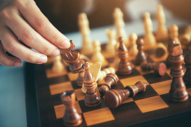 istock Businessman moving chess figure with team behind - strategy or leadership concept 1071254014