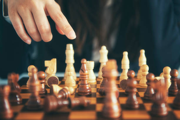 istock Businessman moving chess figure with team behind - strategy or leadership concept 1071254016