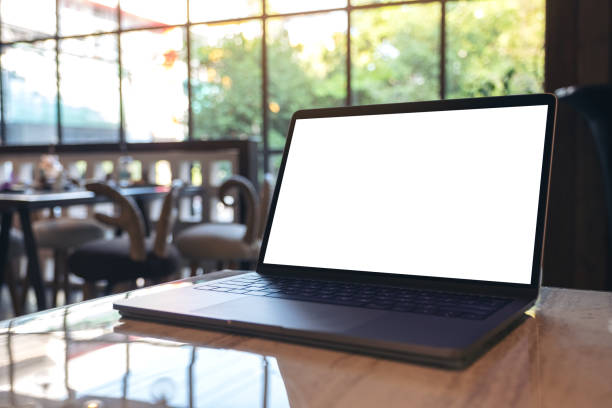 istock Mockup image of laptop with blank white desktop screen on table in cafe 1071259968