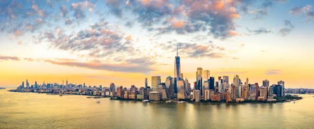 Aerial panorama of New York City skyline at sunset Aerial panorama of New York City skyline at sunset with both midtown and downtown Manhattan lower manhattan stock pictures, royalty-free photos & images