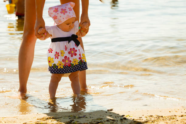 istock Mother playing with baby on beach 1071266162