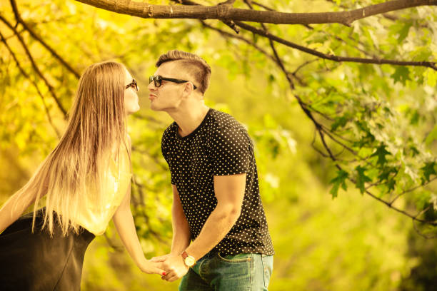 istock Couple in park share a kiss. 1071267588