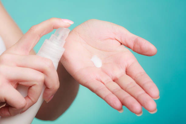 istock Woman putting white cream on hand 1071267728