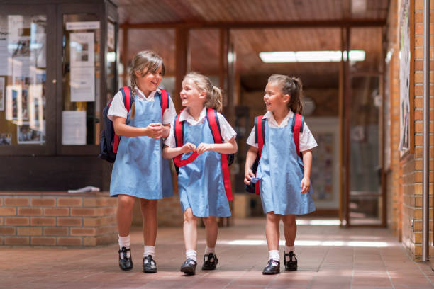 istock Happy cute girls leaving from school 1071269310