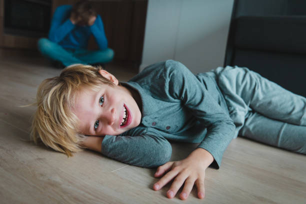 istock difficult parenting- father is tired while son smiles, makes mischief 1071287426