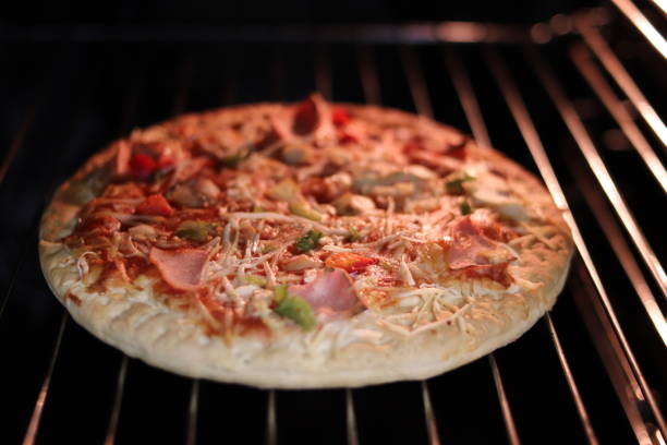 istock Pizza with ham and cheese in the electric oven. 1071287836