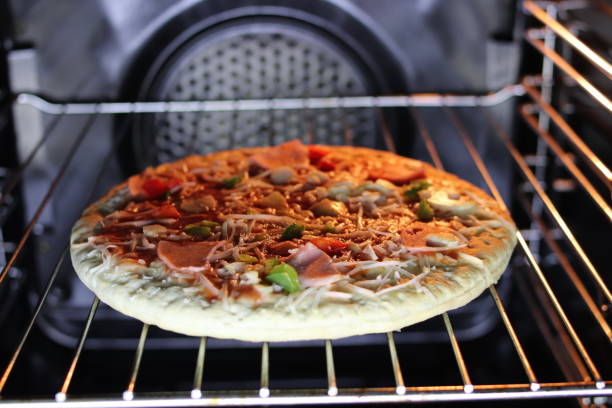 istock Pizza with ham and cheese in the electric oven. 1071287900