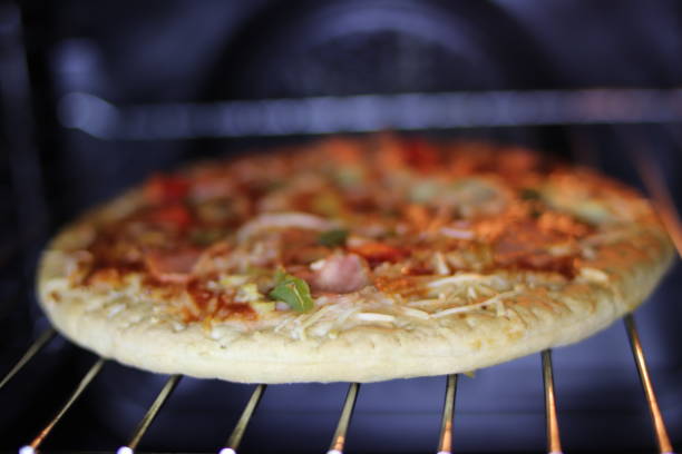 istock Pizza with ham and cheese in the electric oven. 1071287984
