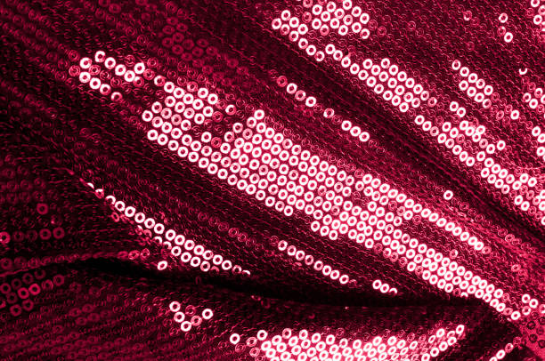 istock Background texture, pattern. Cloth red maroon with paillettes. Look at these Neon Pink Paillette Sequins. Round neon pink paillette sequins overlap with an iridescent sheen across a sheer purple mesh 1071291032