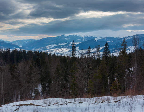 istock Evening winter mountain ridge and sun rays from cloudy sky 1071294352