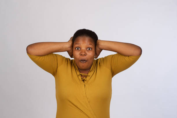 istock Beautiful African woman cut out shock hands on head 1071304052