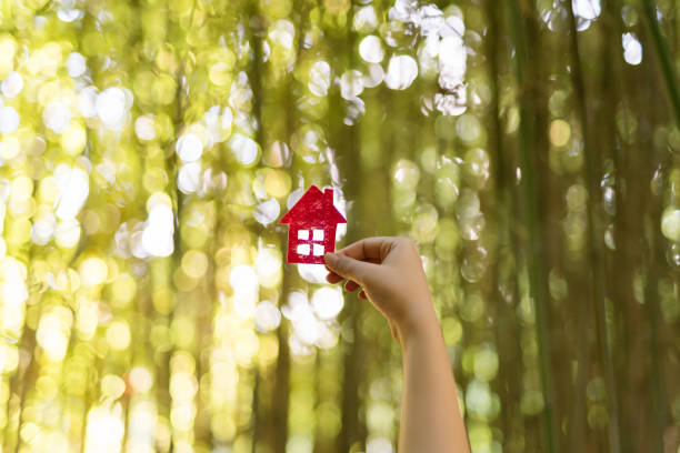 istock Paper house in hand outdoor 1071307686
