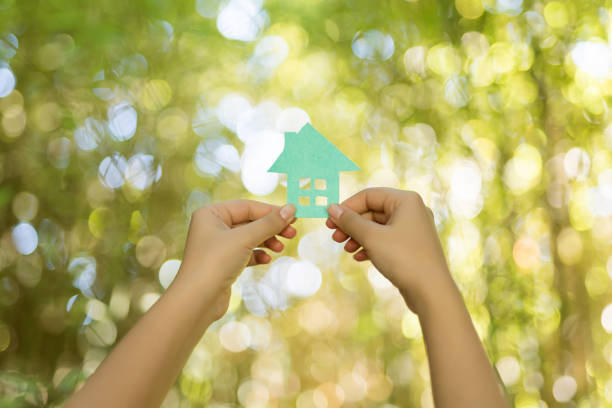 istock Paper house in hand outdoor 1071307746