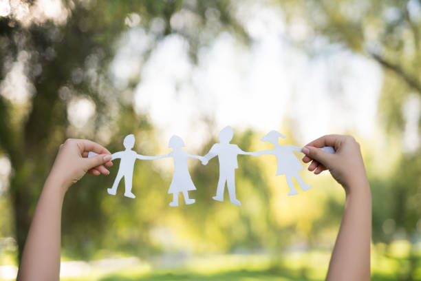 istock Holding a paper doll family 1071307802