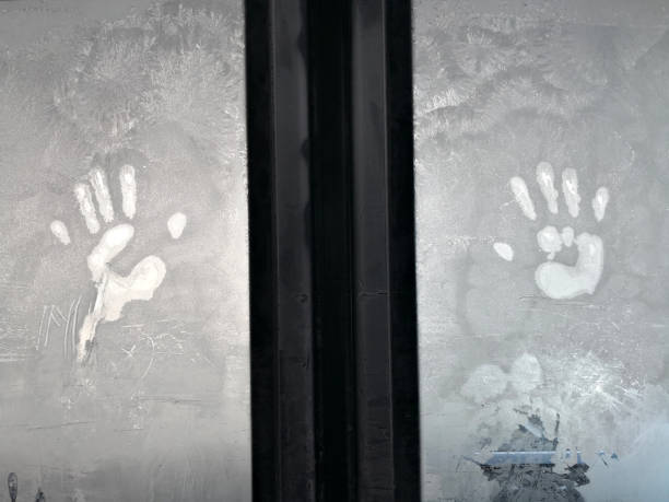 istock Palms imprint on a frosty window 1071308342