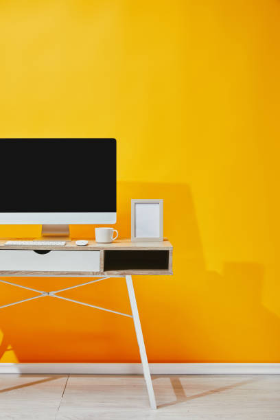 istock Computer, photo frame and cup of coffee at wooden table 1071308890
