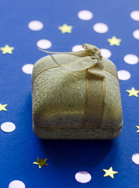 istock Gold box with decoration as a gift on a blue background. 1071315682