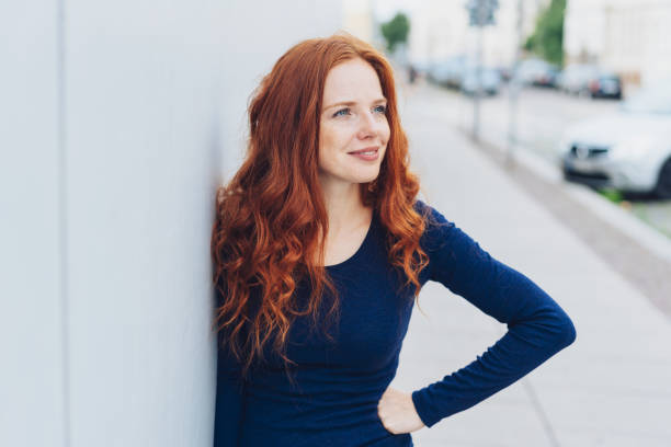 istock Young woman standing watching in town 1071316090