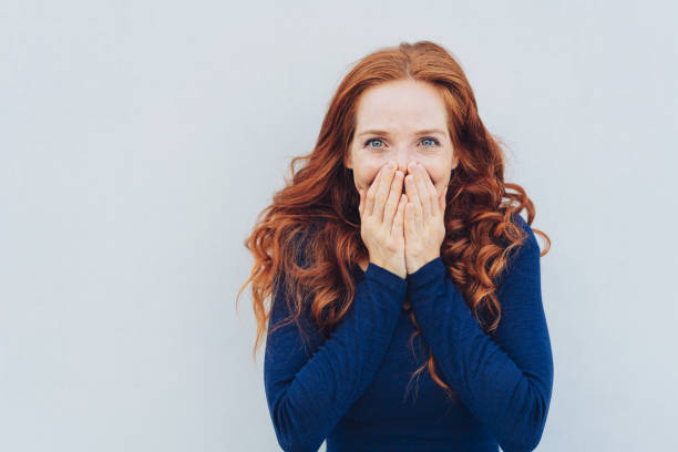 istock Embarrassed young woman covering her face 1071317486