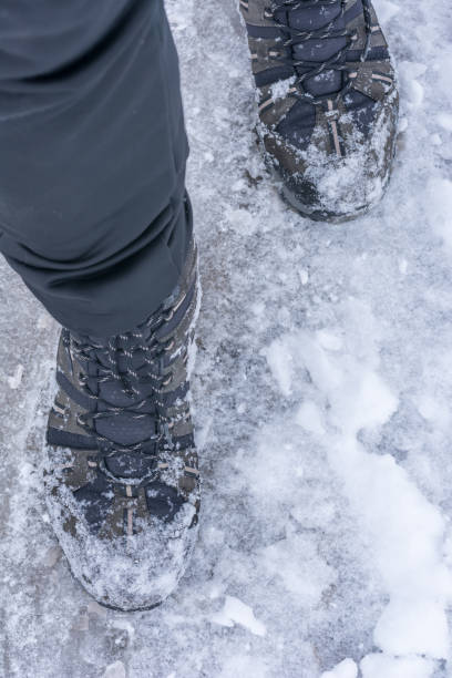 istock Man goes through the snow with warm winter boots 1071317778