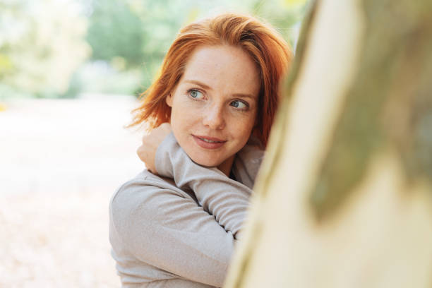 istock Attractive redhead woman outdoors in a park 1071318208