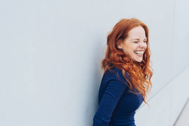 istock Attractive young woman standing giggling 1071318536