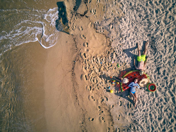 istock Beautiful beach with family top view shot 1071322938