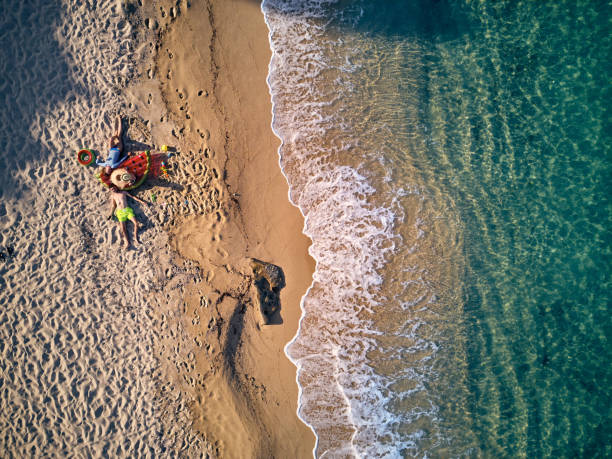 Beautiful beach with family top view shot Beautiful beach with family top aerial view drone shot, Sithonia, Greece halkidiki beach stock pictures, royalty-free photos & images