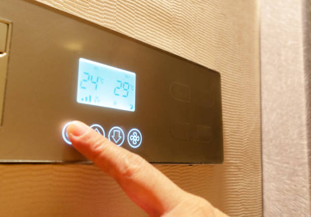 istock touching the control panel of smart hotel room 1071323648