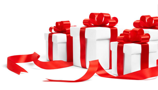 istock Christmas gift boxes with red ribbons on white background 1071324670