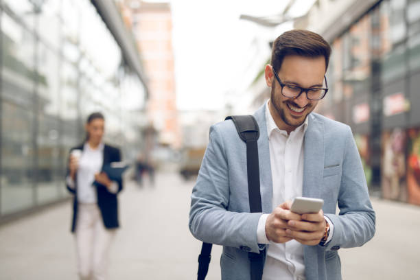 istock Young businessman typing text message on his way to work 1071325218