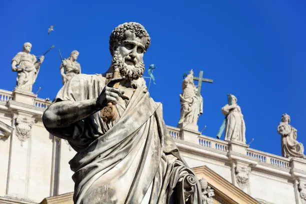 Statue of Saint Peter holding a key on St. Peter's Square in Vatican