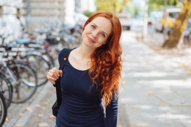 istock Friendly young redhead woman wearing a backpack 1071327218