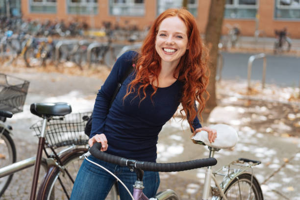 istock Smiling happy young student with her bicycle 1071327366