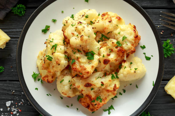 istock Roasted cauliflower with cheddar cheese sauce and herbs. 1071328562