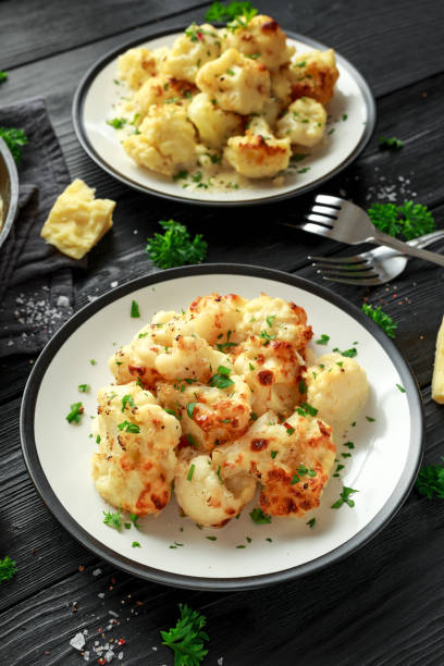 istock Roasted cauliflower with cheddar cheese sauce and herbs. 1071328564