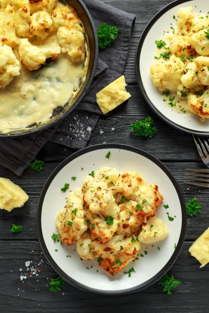 istock Roasted cauliflower with cheddar cheese sauce and herbs. 1071328574