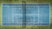 Top view of a blue old tennis court.