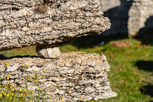 Two limestone rocks (karst erosion) with a pebble in the Regional Natural Park of Lessinia (Valle delle Sfingi), Veneto, Verona, Italy, Europe