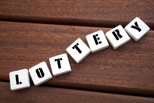 istock LOTTERY Concept with alphabet blocks on wooden table. 1071335348