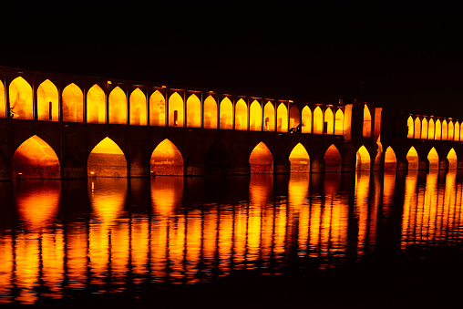 Night shot of the Si-o-seh pol (or Allāhverdi Khan) Bridge in Isfahan, Iran. This bridge is one of the most beautiful and also the longest bridge on Zayandeh River with the total length of 297.76 metres (976.9 ft). It is highly ranked as being one of the most famous examples of Safavid bridge design.
