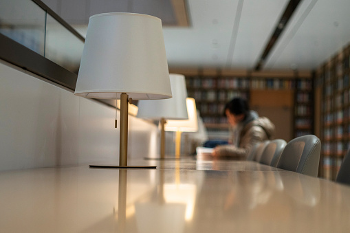 girl reading book in library