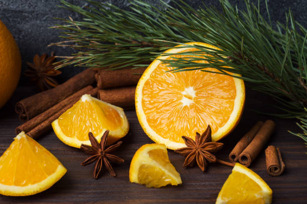 istock Christmas concept with cinnamon, fresh oranges and fir branches on a dark background with copy space. 1071343174