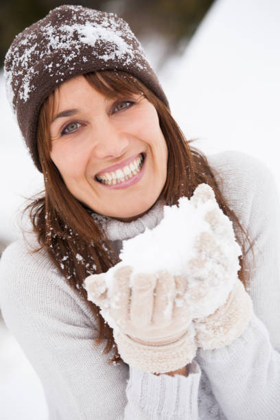 istock smiling woman having fun in the snow 1071344146