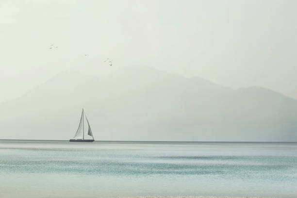 sailboat glides lightly on the waves of a pristine ocean