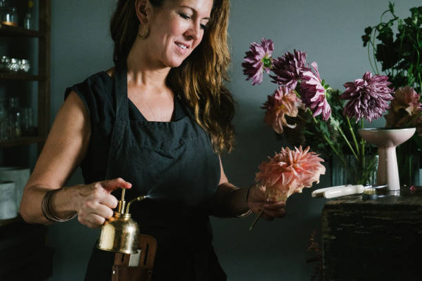 istock Florist misting flowers 1071346176