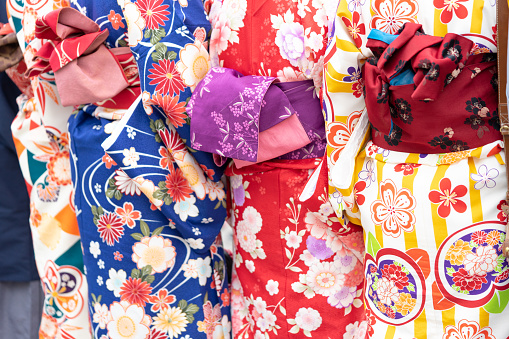 Young girl wearing Japanese kimono standing in Tokyo, Japan. Kimono is a Japanese traditional garment. The word 