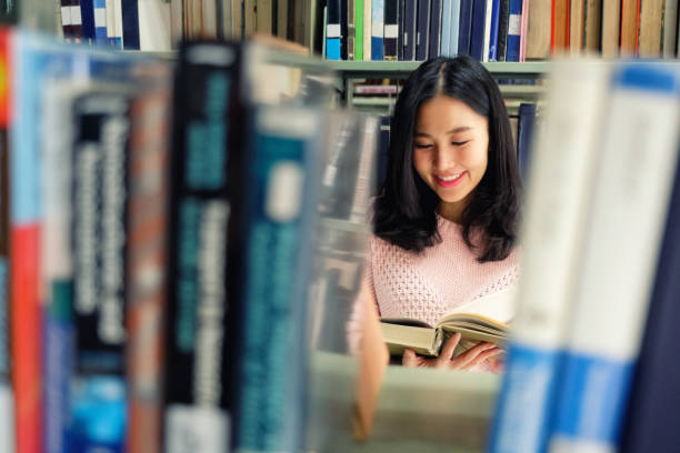 istock Young woman studying in a library 1071347916